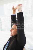 Peaceful businessman stretching his arms
