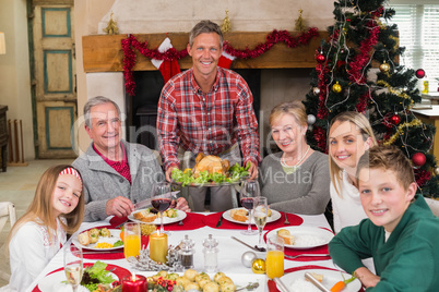 Man serving roast turkey at christmas