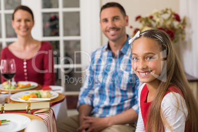 Portrait of cute girl with her parents behind