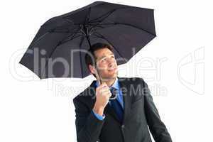 Businessman sheltering with black umbrella