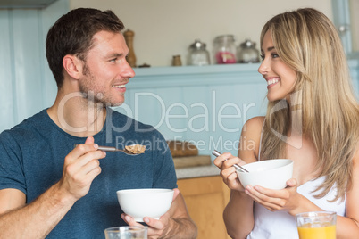 Cute couple having cereal for breakfast