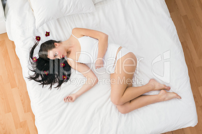 Pretty brunette posing in bed