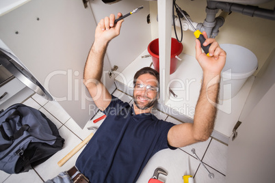 Plumber fixing under the sink