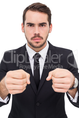 Frustrated businessman with closed fists looking at camera