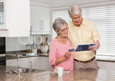 Senior couple shopping online with tablet pc