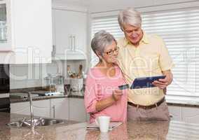 Senior couple shopping online with tablet pc