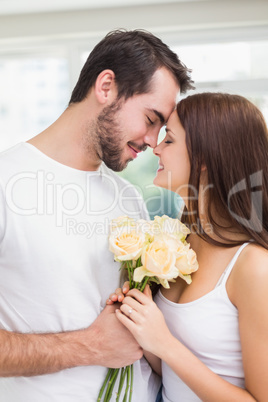 Young man giving girlfriend white roses