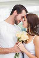 Young man giving girlfriend white roses