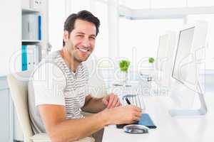 Casual man working at desk with computer and digitizer