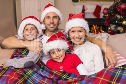 Festive family hugging under the cover