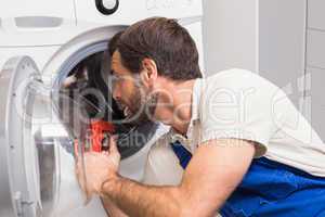 Handyman fixing a washing machine