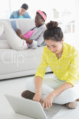 Young creative woman working on floor