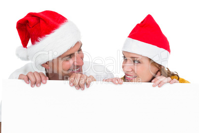 Festive couple showing a poster