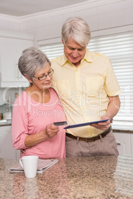 Senior couple shopping online with tablet pc