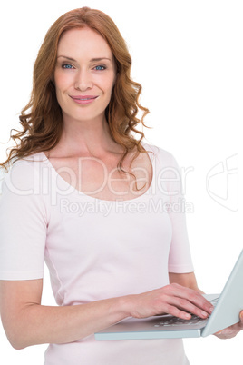 Pretty redhead using a laptop