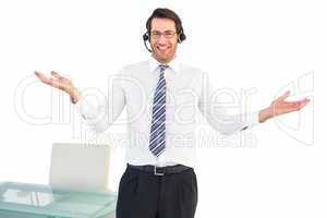 Smiling businessman presenting and wearing headphone