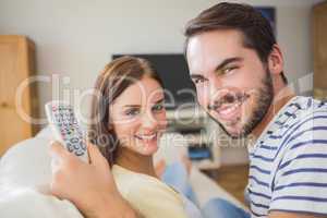 Cute couple watching tv on the couch