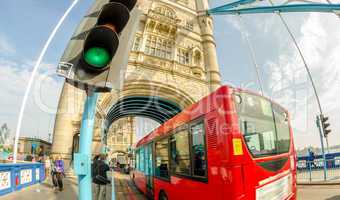 Double Decker red bus crossing Tower Bridge