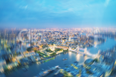 London at night. Blurred aerial view of Tower Bridge area and ci