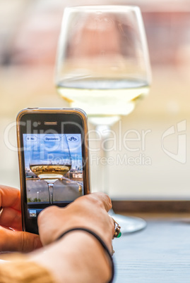 Wine glass in front of London skyline, mobile photography concep