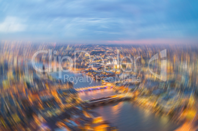 London at night. Blurred aerial city view with Thames river and