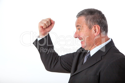 Serious businessman clenches his fist with joy