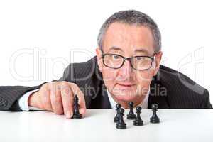 Men with chess pieces on the desk