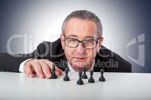 Men with chess pieces on the desk