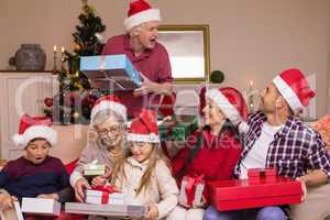 Grandfather giving gift to his family