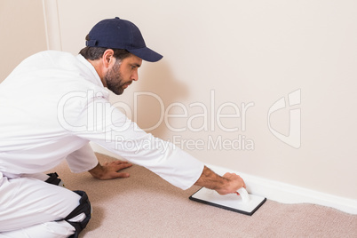 Handyman laying down a carpet