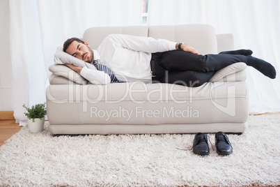 Businessman sleeping on couch after long day