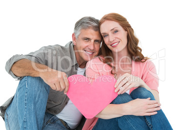 Casual couple holding pink heart