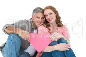 Casual couple holding pink heart