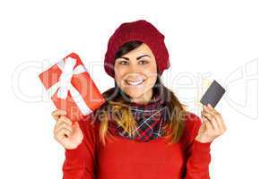 Happy brunette holding gift and cards