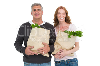 Casual couple holding grocery bags