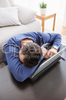 Young man sitting on floor using laptop
