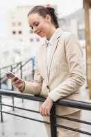 Young businesswoman sending a text