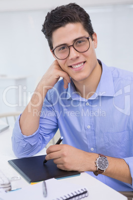 Casual graphic designer working at his desk