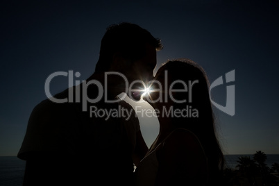 Cute couple kissing in silhouette