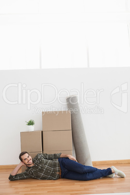 Happy man posing with moving boxes