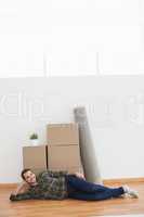 Happy man posing with moving boxes