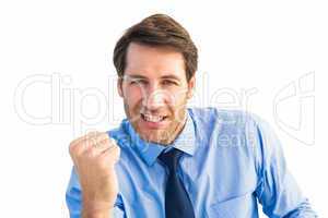 Cheerful businessman clenching fist looking at camera