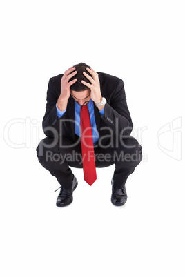 Worried businessman with head in hands