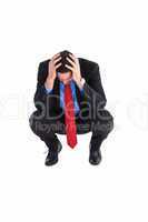 Worried businessman with head in hands