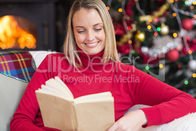 Pretty blonde reading book at christmas time