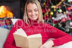 Pretty blonde reading book at christmas time