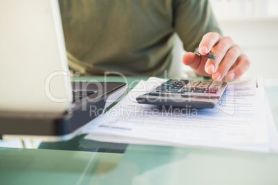 Man using laptop and calculator