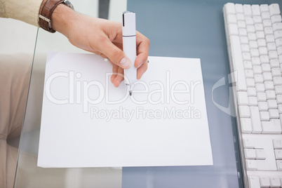 Hand of a businessman writing with a marker