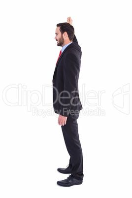 Smiling businessman standing with hand raised