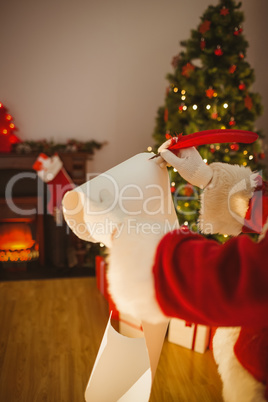 Father christmas writing with a quill